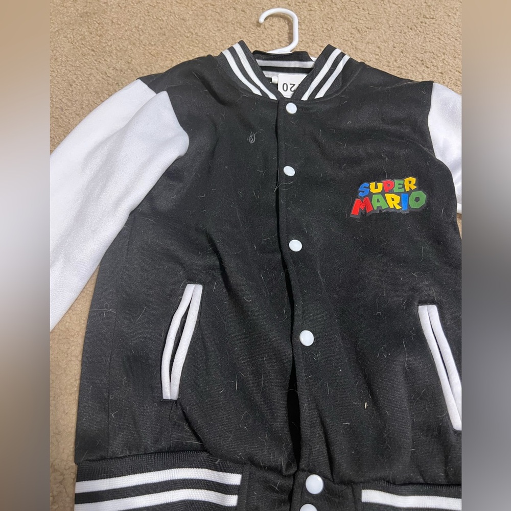 Super Mario collegiate jacket size 120 size 6. Black and white NWT
